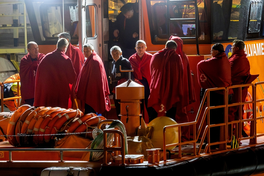 Survivors of the sinking of Russian cargo ship Ursa Major stand on the deck of a Spanish Maritime Rescue ship upon arrival at the port of Cartagena, Spain December 23, 2024. — Reuters pic  