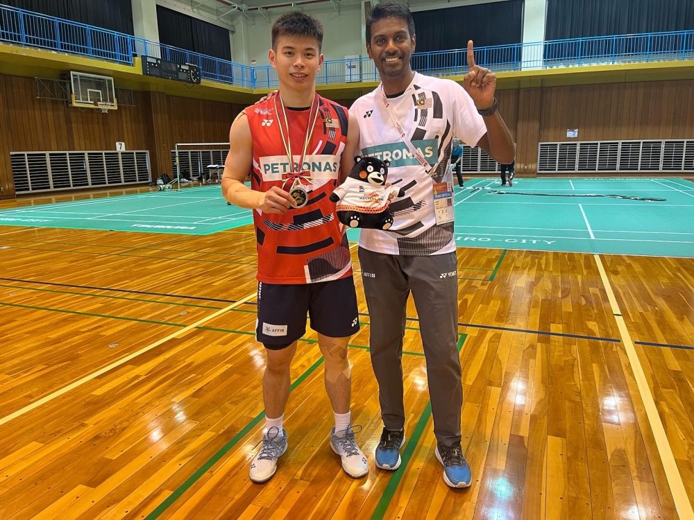 Although Yogendran has not set specific targets for the Malaysia Open, he remains optimistic that the results will follow if his players execute their strategies effectively. Here, he is seen with national men’s singles shuttler Leong Jun Hao. — Picture via Facebook