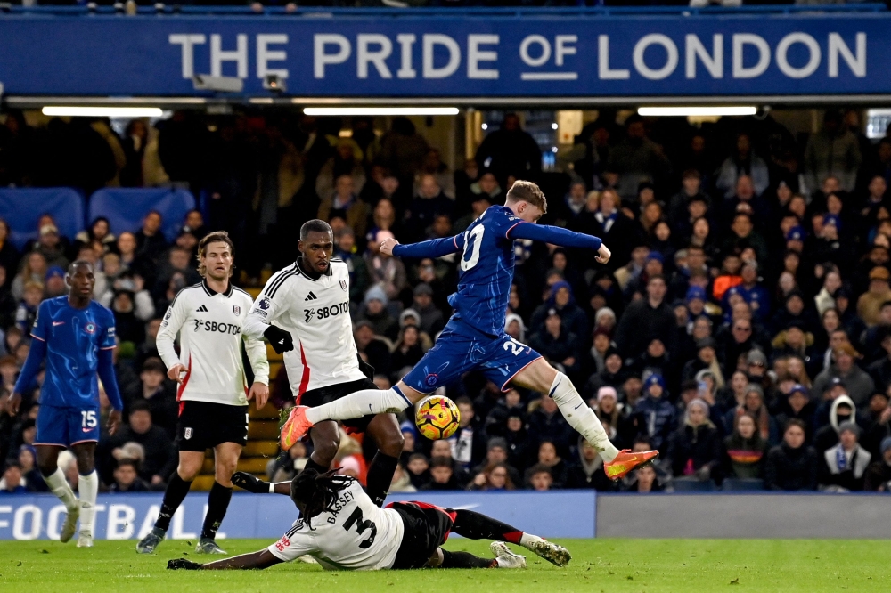 Chelsea’s Cole Palmer leaps over Fulham’s Calvin Bassey during their English Premier League match at Stamford Bridge in London December 26, 2024. — AFP pic
