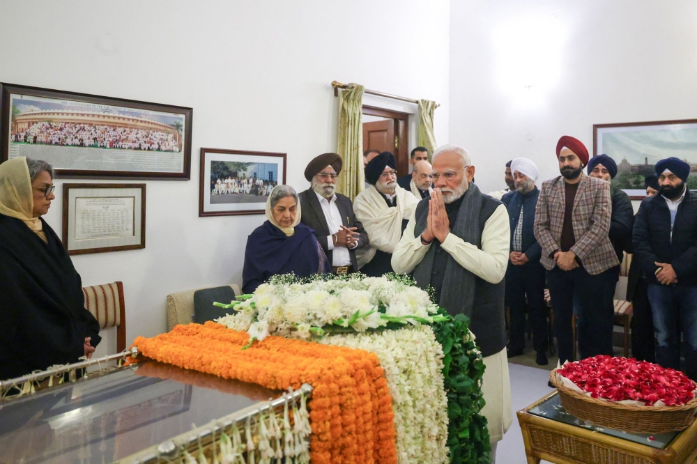 India’s Prime Minister Narendra Modi pays last respects to former Indian prime minister Manmohan Singh at his residence in New Delhi December 27, 2024. — AFP pic