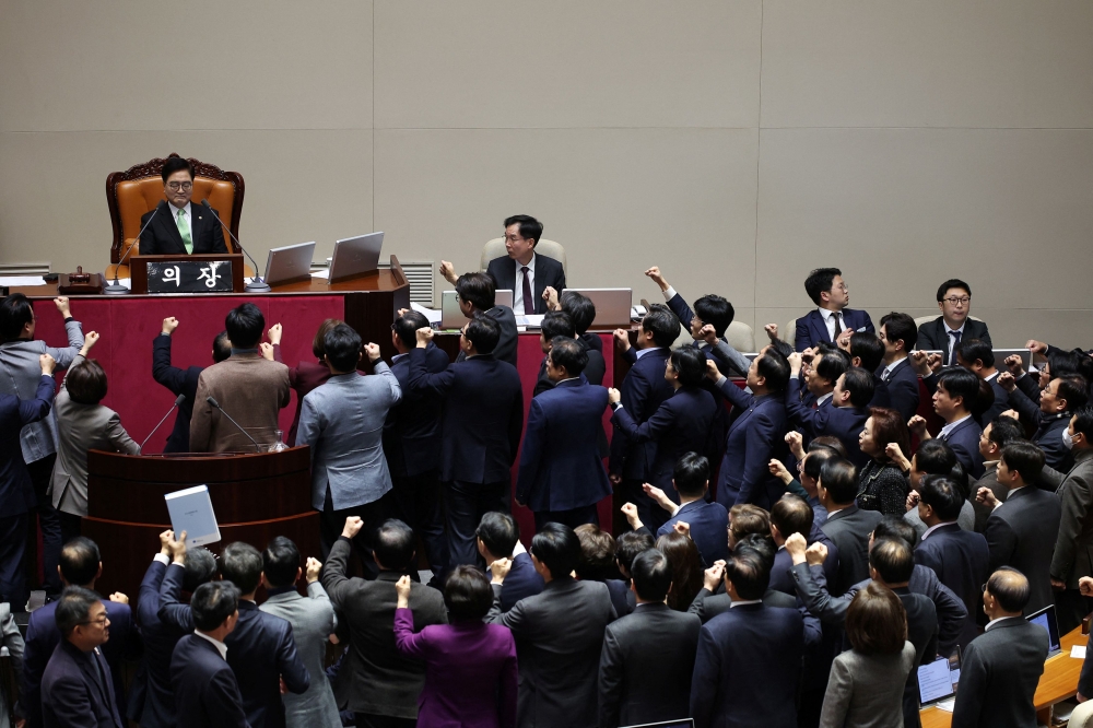 South Korea’s ruling People Power Party lawmakers protest against National Assembly Speaker Woo Won-shik during the impeachment vote of a plenary session for South Korean acting President and Prime Minister Han Duck-soo at the National Assembly in Seoul December 27, 2024.