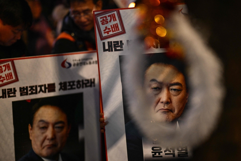 South Korea’s suspended president Yoon Suk-yeol authorised the military to fire their weapons if needed to enter parliament during his failed bid to impose martial law, according to a prosecutors’ report seen by AFP today. — AFP pic