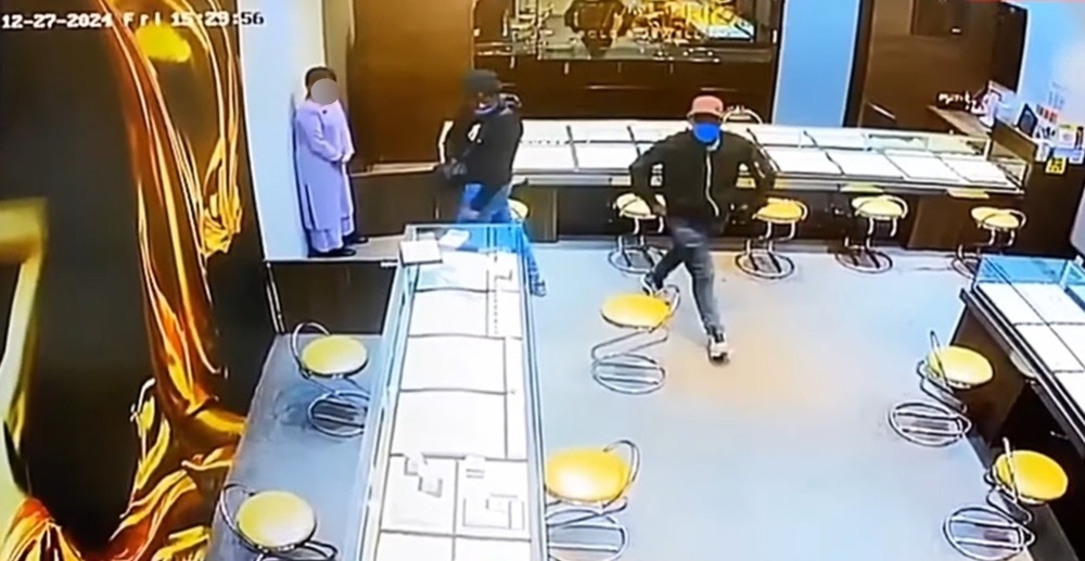 Two men robbed a jewellery store at a shopping mall in Banda Hilir yesterday afternoon. — Screengrab via CCTV footage on social media