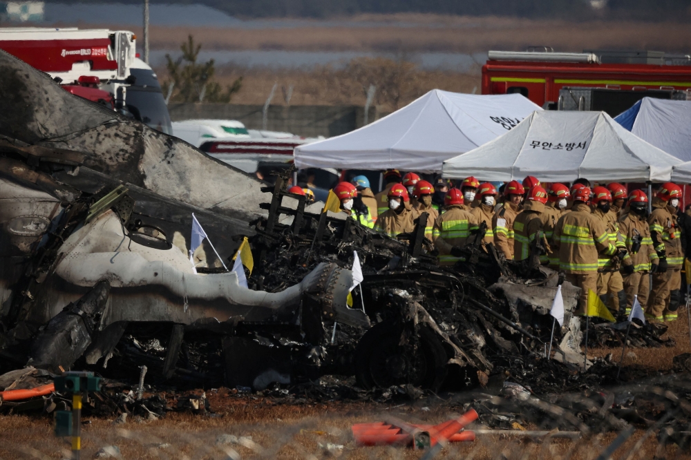 Rescue workers take part in a salvage operation at the site where an aircraft crashed after it went off the runway at Muan International Airport, in Muan, South Korea, December 29, 2024. — Reuters pic 