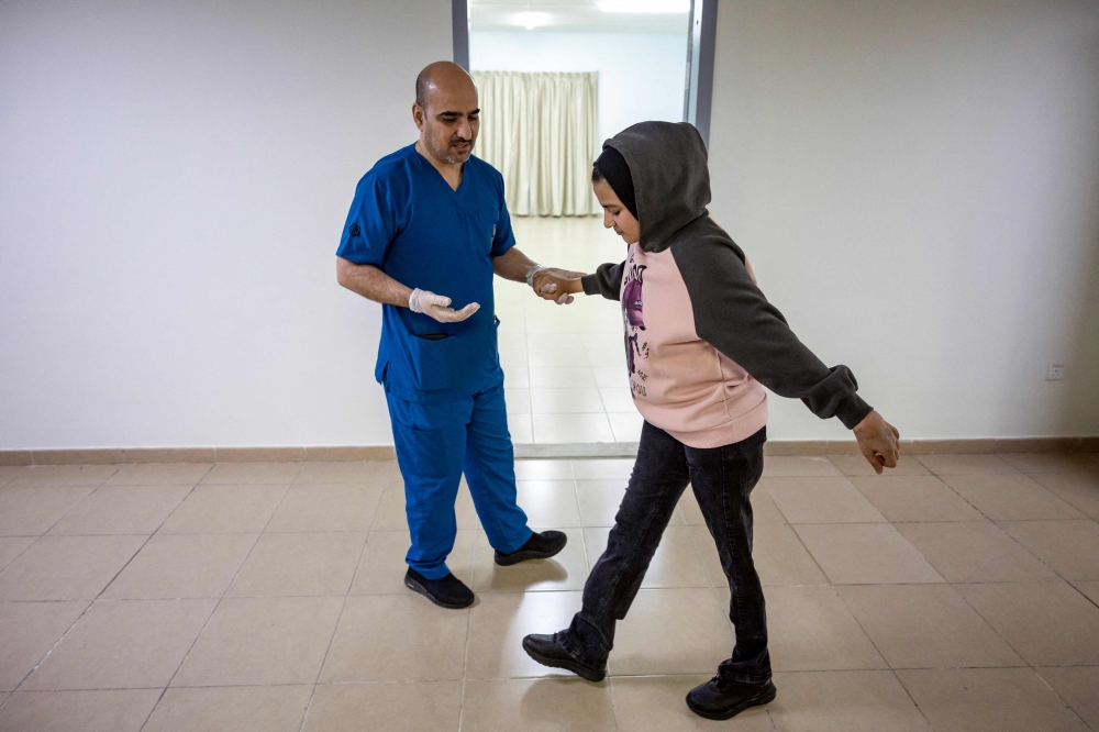 A Palestinian amputee who was injured in the Gaza Strip during the war between Israel and Hamas, receives rehabilitation care at a hospital in Abu Dhabi December 12, 2024. — AFP pic