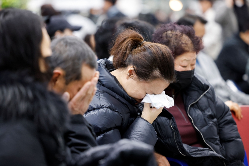 Relatives of passengers of the aircraft that crashed after it went off the runway, react at Muan International Airport, in Muan, South Korea, December 29, 2024. — Reuters pic