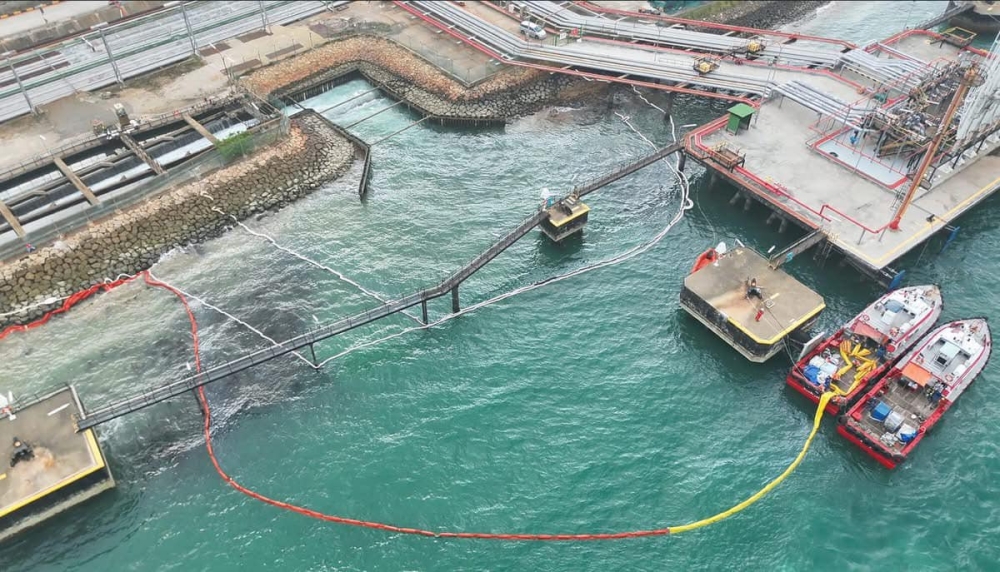 Containment measures, including the deployment of oil-absorbent booms and dispersants, in place at the discharge channel. — Picture via Facebook/NEA