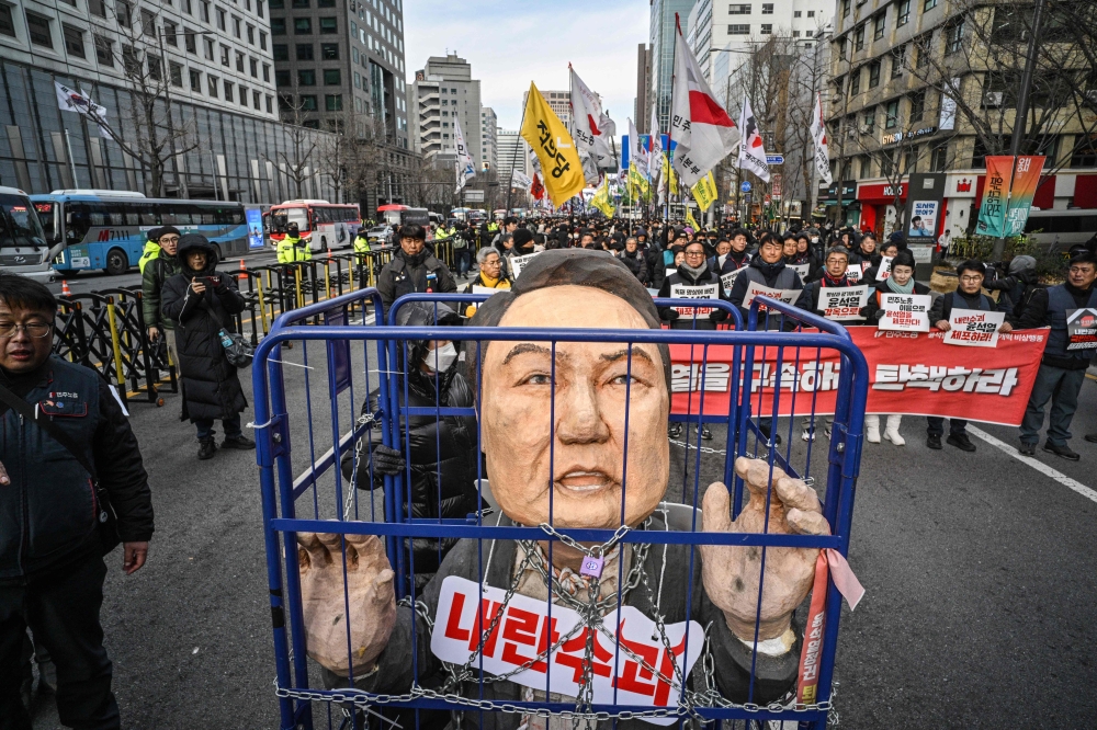 File photo of demonstrators from a labour group take part in a protest calling for the ouster of South Korea's President Yoon Suk Yeol outside City Hall in Seoul on December 12. — AFP