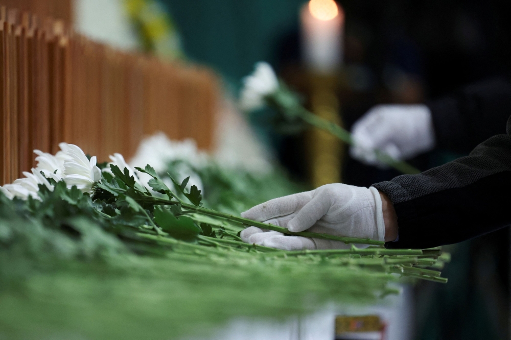 Nuns lay flowers at a memorial altar for the victims of the Jeju Air crash at Muan International Airport. — Reuters 