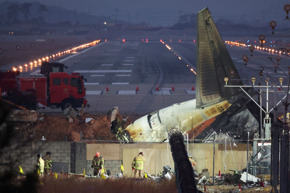 Rescues work near the wreckage of the Jeju Air aircraft that went off the runway and crashed at Muan International Airport. — Reuters