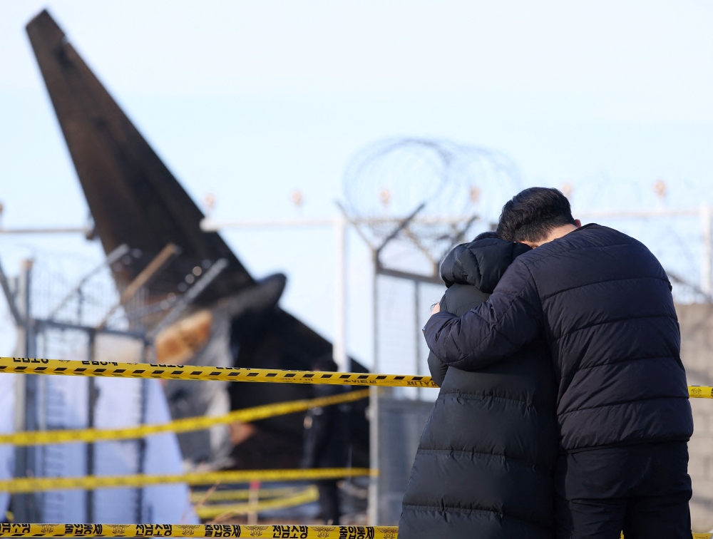 South Korean authorities began releasing the bodies of plane crash victims to families today, as investigators raced to determine why the Jeju Air Boeing 737-800 crash landed and burst into flames. — AFP pic