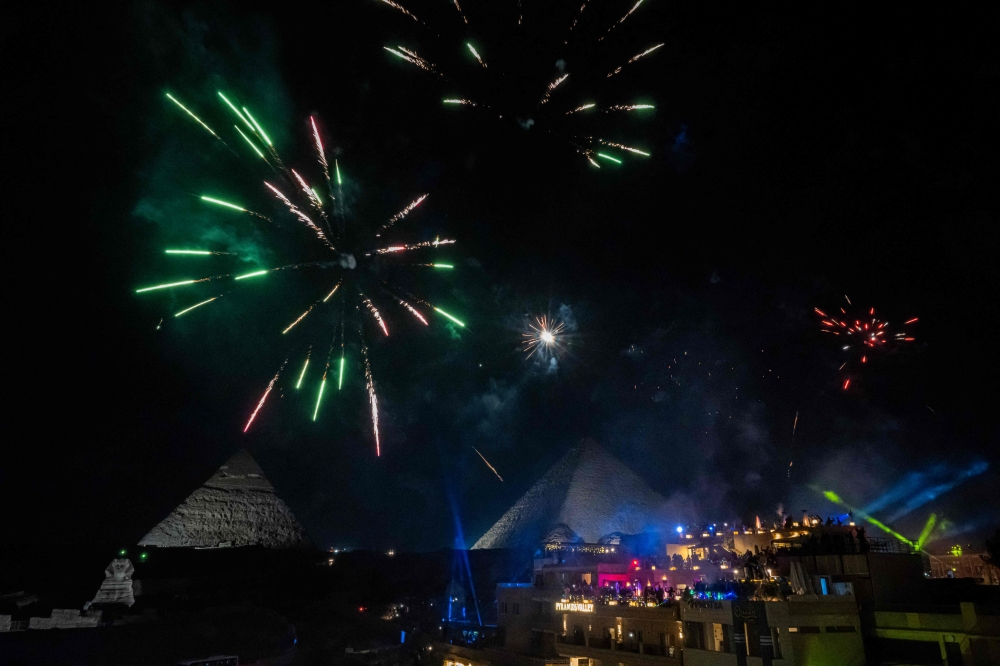 Fireworks explode above the Great Pyramids New Year's celebrations in Cairo on December 31, 2024. — AFP pic