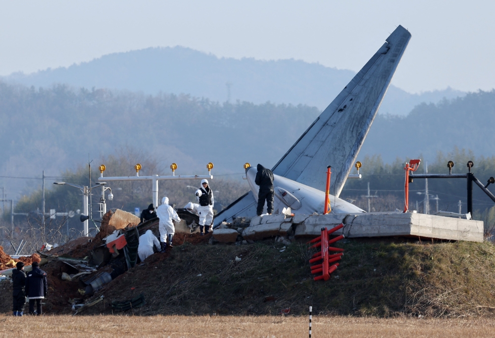 File photo of investigations at the site where a Jeju Air Boeing 737-800 aircraft crashed and burst into flames at Muan International Airport. — AFP