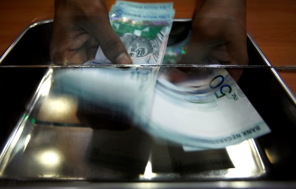 The ringgit finished lower against the US dollar on the first trading day of the year on continuous demand for the greenback due to concerns over the US Federal Reserve’s (Fed) potential decision to cut interest rates in 2025. — Reuters pic