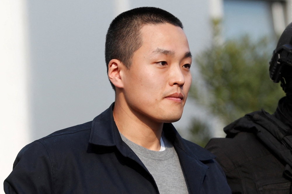 Police officers escort Terraform Labs co-founder Do Kwon after he served a sentence for document forgery, in Podgorica, Montenegro, March 23, 2024. — Reuters pic  