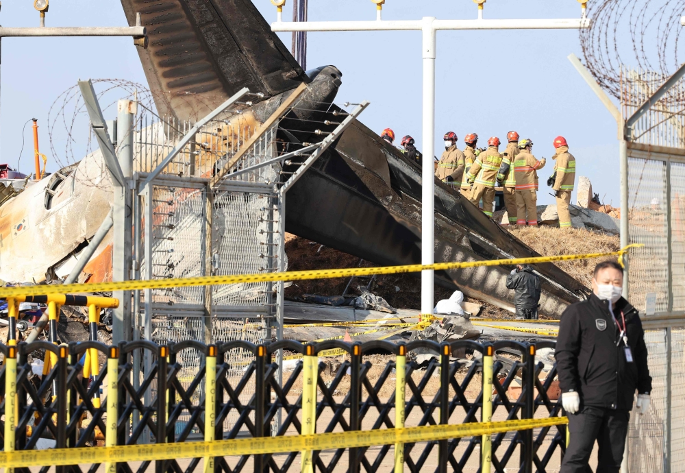 Teams work at the site of the Jeju Air Boeing 737-800 aircraft which crashed and burst into flames at Muan International Airport, in Muan on January 3, 2025. — Yonhap/AFP pic