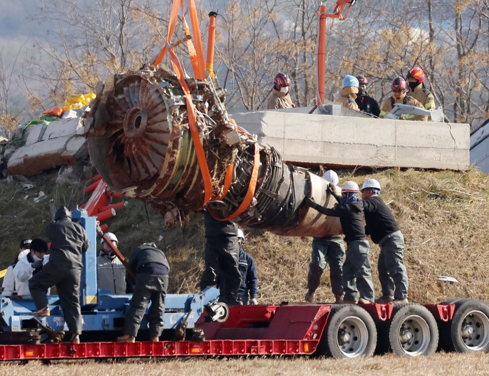 Teams salvage an engine of the Jeju Air Boeing 737-800 aircraft which crashed and burst into flames at Muan International Airport, in Muan on January 3, 2025. — Yonhap/AFP pic