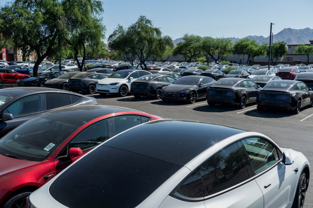 Tesla electric vehicles are parked in a storage lot outside a disused movie theatre in Scottsdale, Arizona, US, June 11, 2024. — Reuters pic