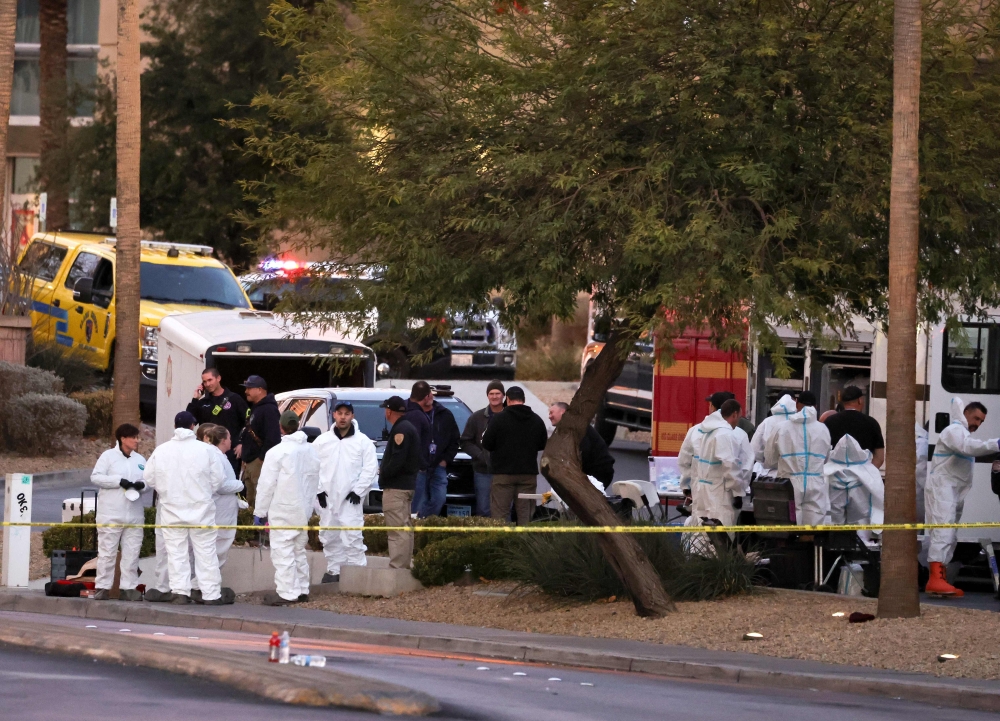 First responders, some wearing Hazmat gear, gather outside the Fashion Show mall across from the Trump International Hotel & Tower Las Vegas as they investigate the Tesla Cybertruck that exploded in front of the hotel’s entrance. — AFP