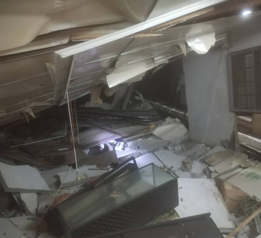 Handout photo shows the aftermath of the house collapse. — Bomba pic