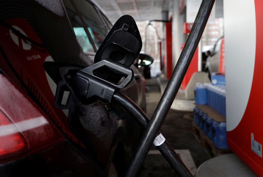 An electric car gets charged at a station that offers car charging points and fuel, in Sandvika near Oslo December 11, 2024. — Reuters pic  
