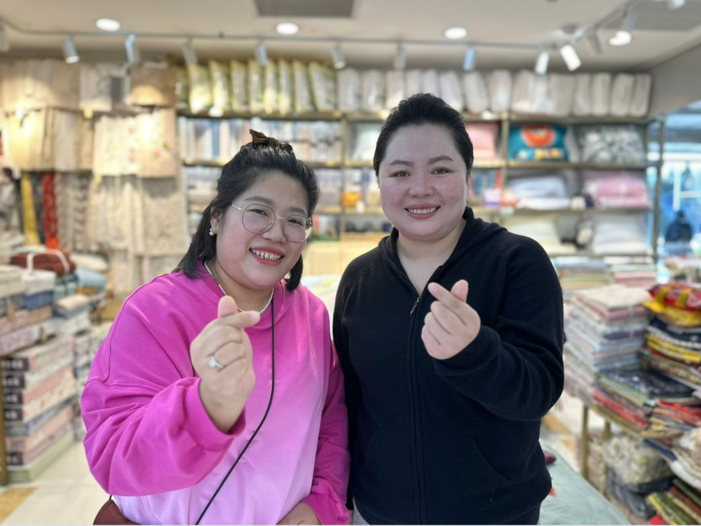 Sisters Fatima Liu (right) and Aisha show off their proficiency in speaking Malay to Malaysian tourists at their shop in Pearl Market, Beijing, China. — Bernama pic