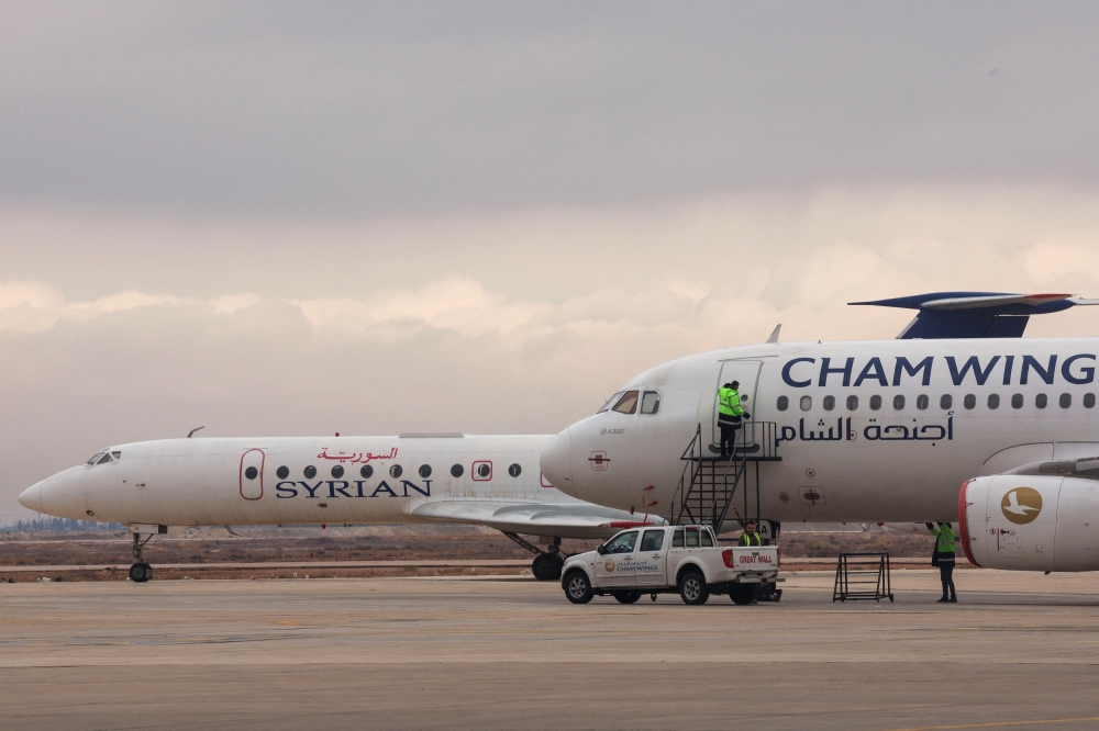 SyrianAir and Cham Wings Airlines' planes are parked at the Damascus International Airport, after the ousting of Syria's Bashar al-Assad, in Damascus, Syria, December 31, 2024. — Reuters pic  