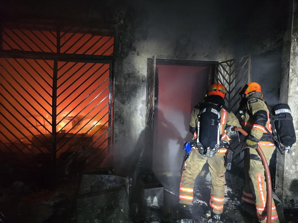Firefighters enter a fire damaged home in Singapore on Jan 5, 2025. — Picture from Facebook/Singapore Civil Defence Force 