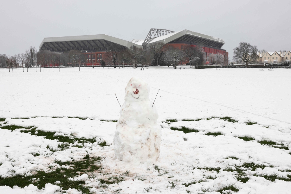 A photograph taken on January 5, 2025 shows a snow man in front of Anfield stadium in Liverpool ahead of the the English Premier League football match between Liverpool and Manchester United, as heavy snow across parts of England are set to cause disruption. An amber weather warning — the second most serious — for snow and freezing rain was in place for much of Wales, central England and parts of north-western England. — AFP pic