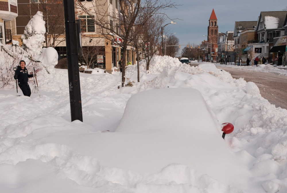 A car is buried in snow on December 28, 2022. — AFP pic