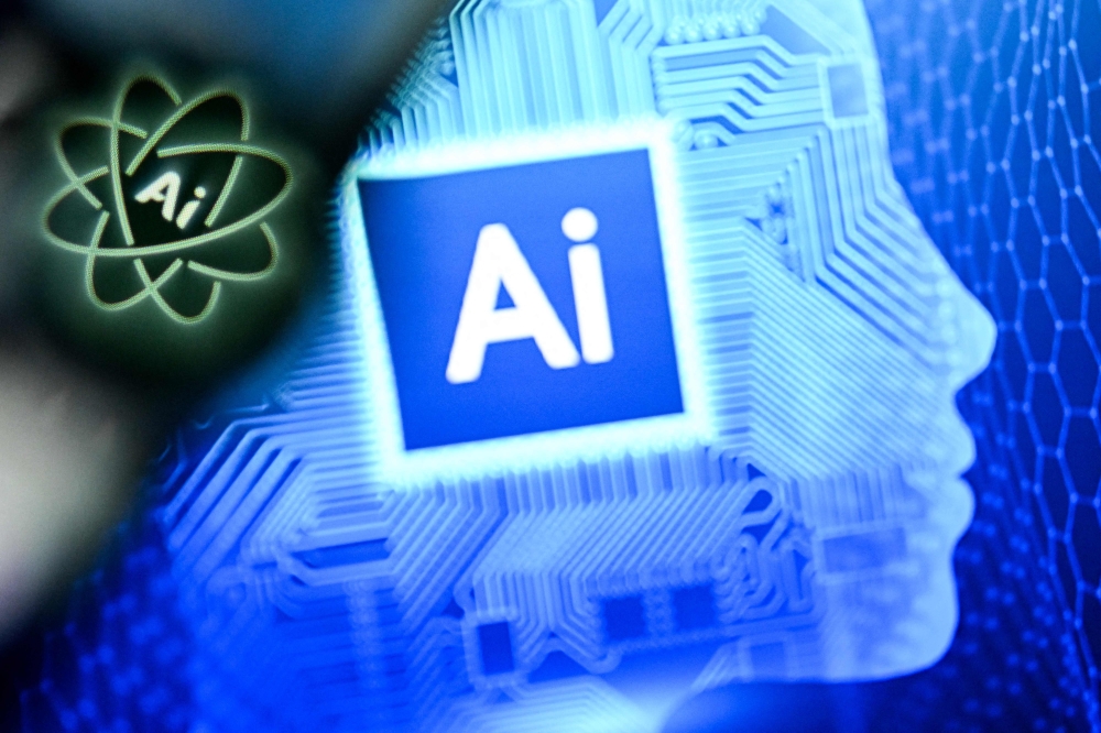 A photo shows the letters AI for Artificial Intelligence on a laptop screen next to the logo of the Chat AI application on a smartphone screen. — AFP pic