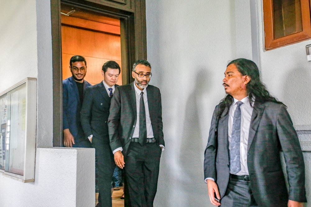 Director Khairi Anwar Jailani (left) together with ‘Mentega Terbang’ film producer Tan Meng Kheng (2nd left) leave the court room with the lawyer N Surendran (2nd right) and Lawyer Zaid Malek (right) at Kuala Lumpur High Court Complex in Kuala Lumpur May 10, 2024. —Picture by Hari Anggara