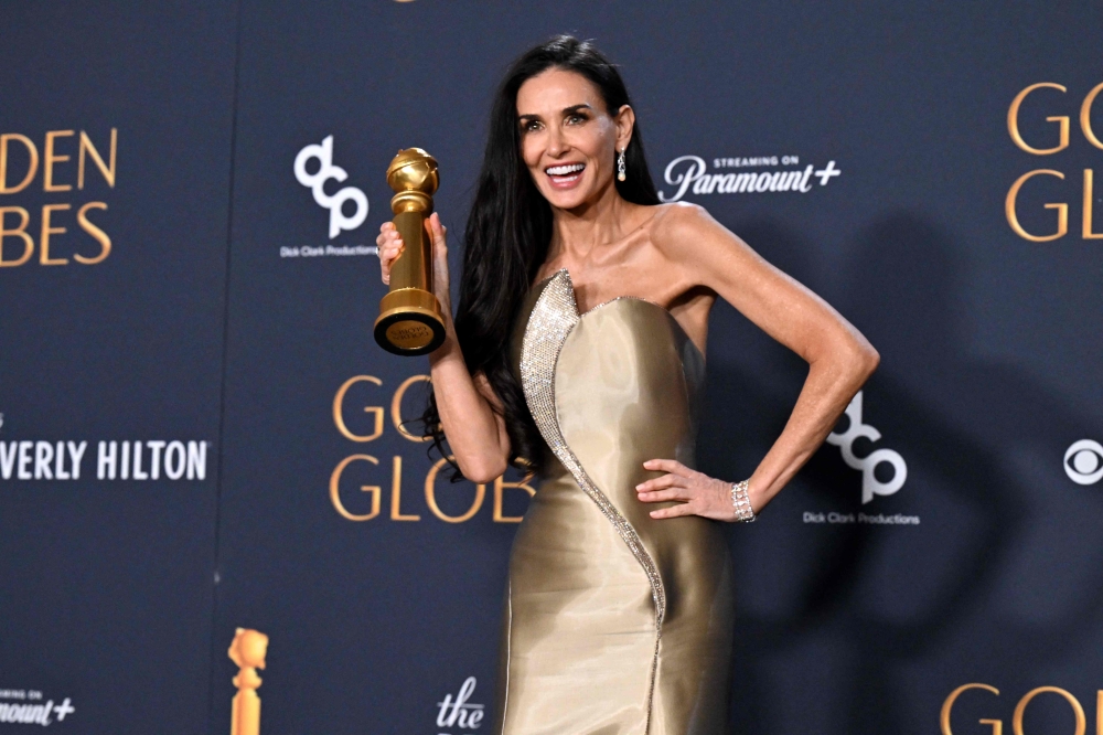 Demi Moore won her first acting award in a career spanning five decades on Sunday, scooping a Golden Globe for the body-horror film ‘The Substance’. — AFP pic