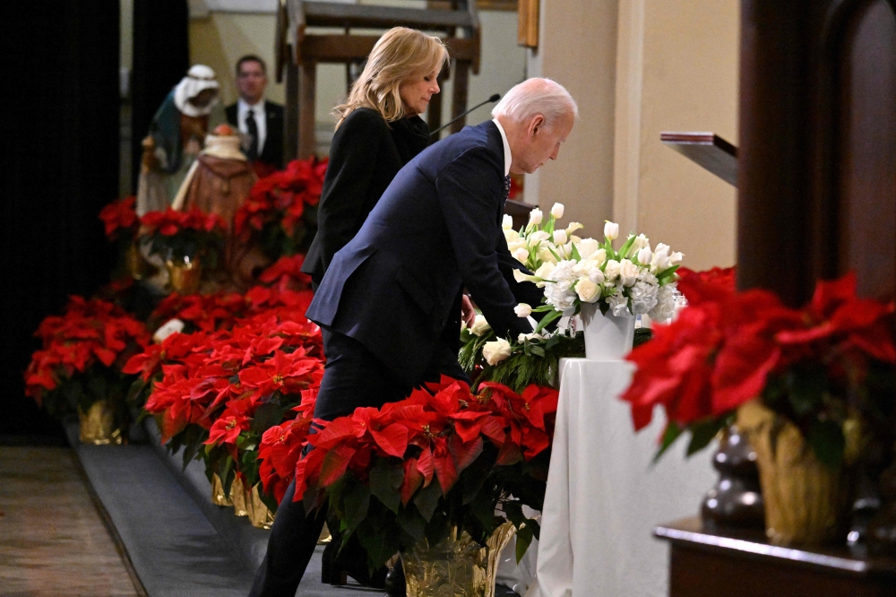 US President Joe Biden and First Lady Jill Biden place a candle, representing those killed, at the altar during an interfaith prayer service with the families and community members impacted by the January 1 truck attack in New Orleans. — AFP