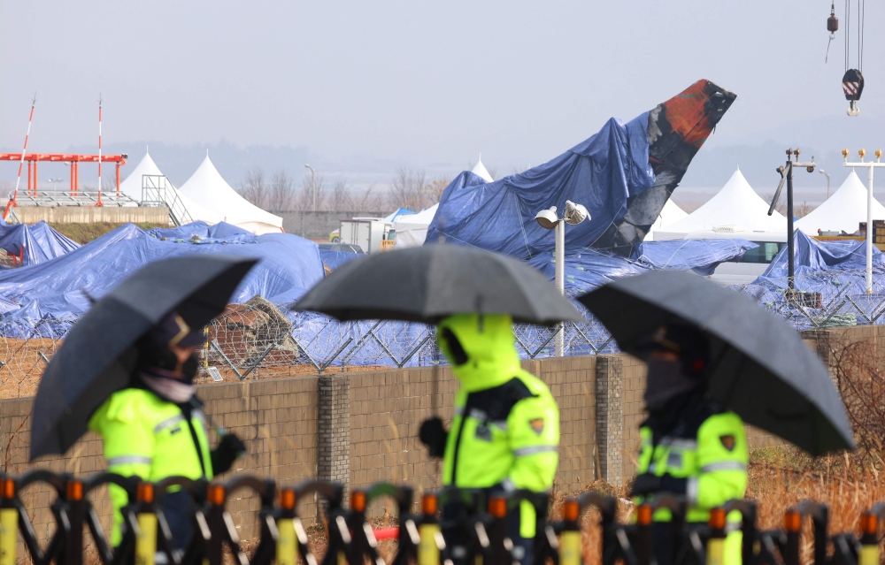 Tarpaulin covers shroud the wreckage of the Jeju Air Boeing 737-800 aircraft, which on December 29 crashed and burst into flames at Muan International Airport in Muan, some 288 kilometres southwest of Seoul, on January 5, 2025. — AFP pic