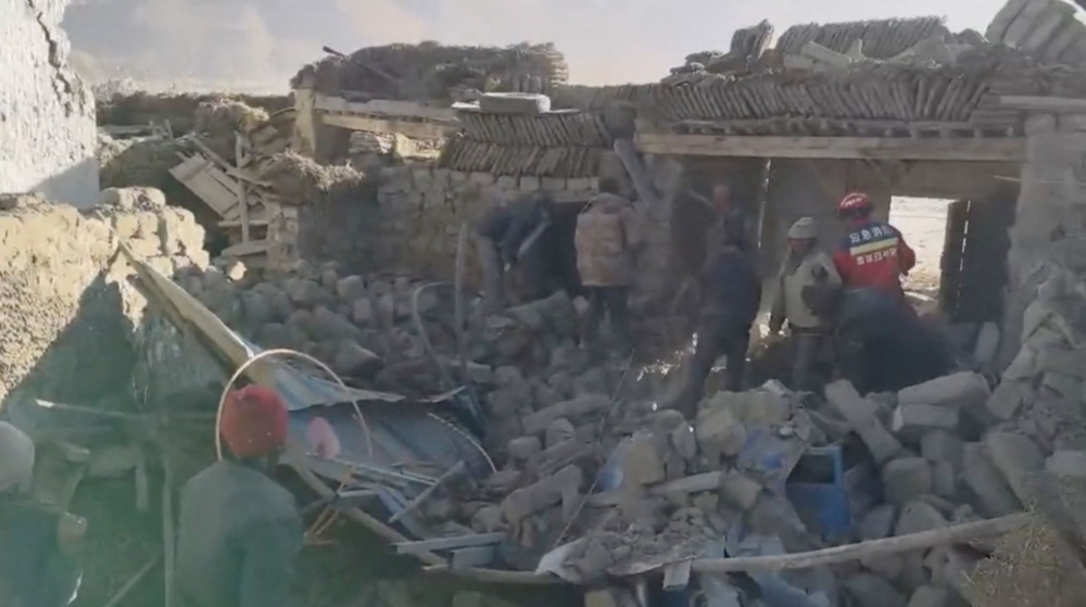 Rescue teams stand amid rubble in the aftermath of an earthquake in a location given as Shigatse City, Tibet Autonomous Region, China, January 7, 2025, in this screengrab obtained from a handout video. — Tibet Fire and Rescue handout via Reuters 