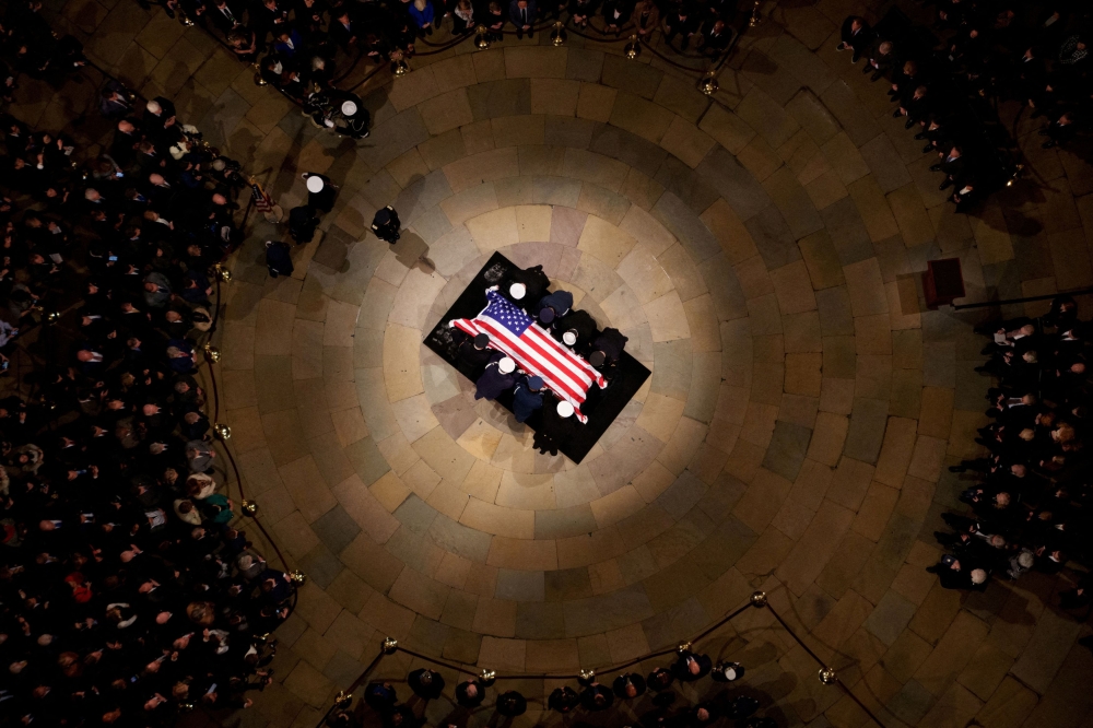 The flag-draped casket of former US President Jimmy Carter lies in state in the US Capitol Rotunda, in Washington, DC, January 7, 2025. — Reuters pic