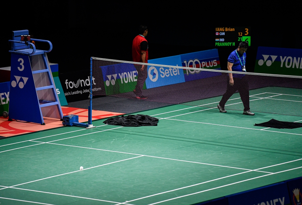 Black cloth rags are placed on the court to soak up the rainwater that leaked through the roof of the Axiata Arena indoor stadium at Bukit Jalil, disrupting badminton matches at two courts during the Malaysia Open on January 7, 2025. — Bernama pic