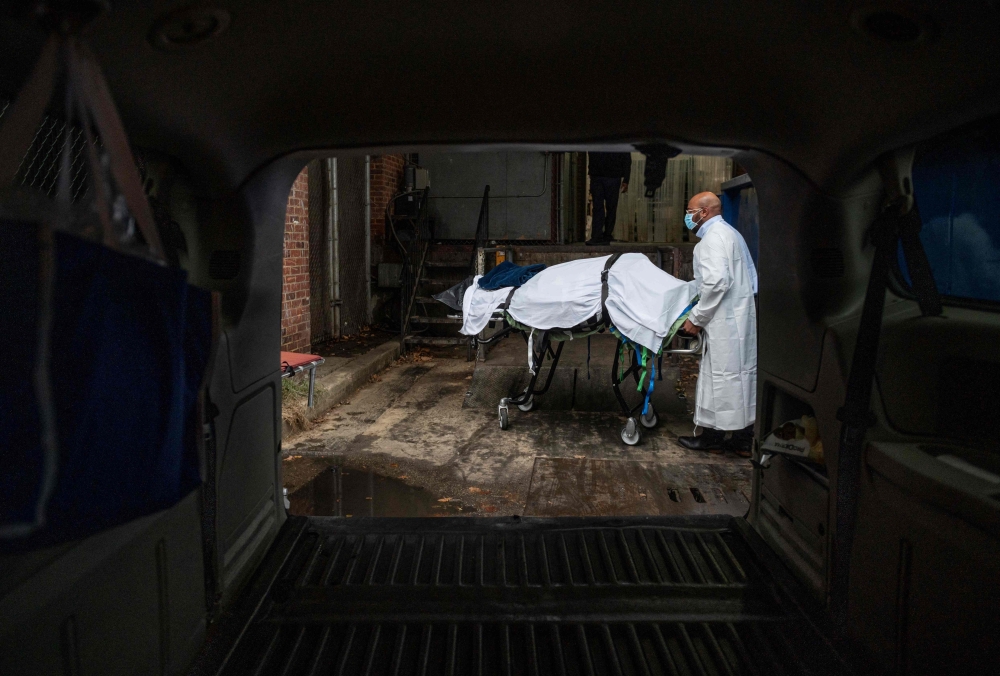 Maryland Cremation Services transporter Reggie Elliott brings the remains of a Covid-19 victim to his van from the hospital's morgue in Baltimore, Maryland on December 24, 2020, during the Covid-19 pandemic. — AFP pic