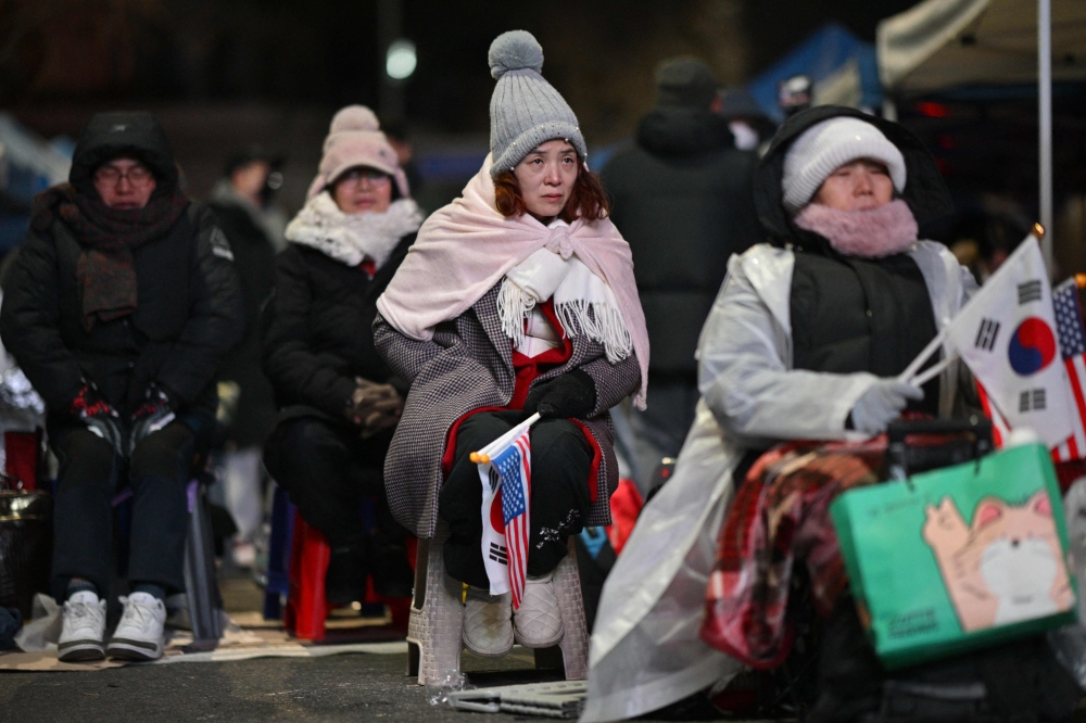 Supporters of impeached South Korea’s president Yoon Suk Yeol attend a rally near his residence in Seoul early on January 8, 2025. — AFP pic 
