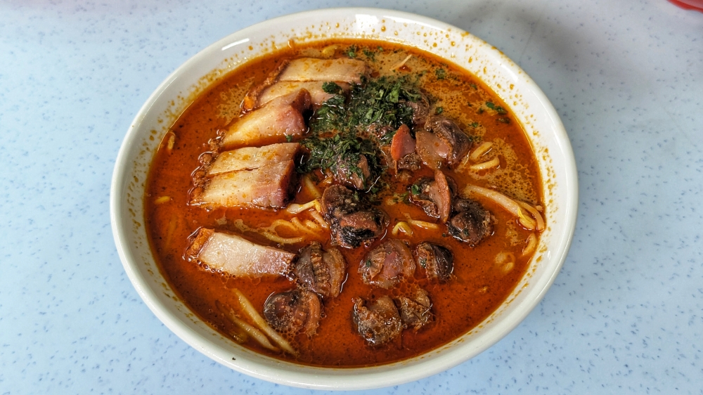 A ‘Nyonya laksa’ unlike any other: topped with ‘siew yoke’ and ‘siham’ — Picture by Ethan Lau