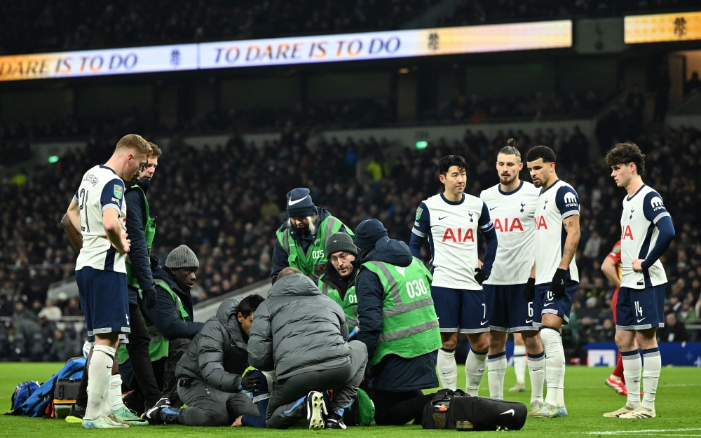 Medical staff treat  Tottenham Hotspur’s injured Rodrigo Bentancur during the English League Cup semi-final first leg match. — AFP