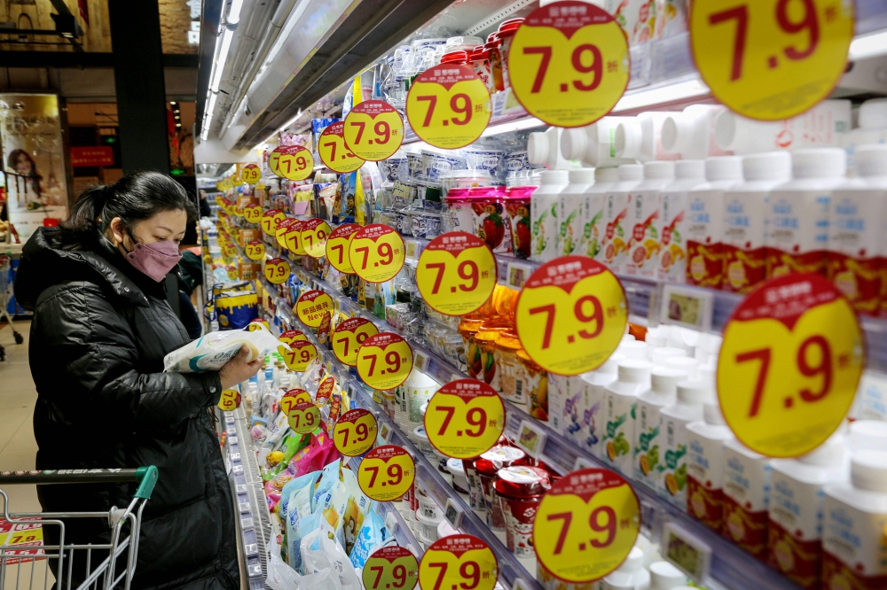 A customer shops for dairy products at a supermarket in Lianyungang, in eastern China’s Jiangsu province January 9, 2025. Sentiment was also clouded by data showing that Chinese consumer inflation remained almost non-existent despite a raft of stimulus measures in the final three months of last year. — AFP pic