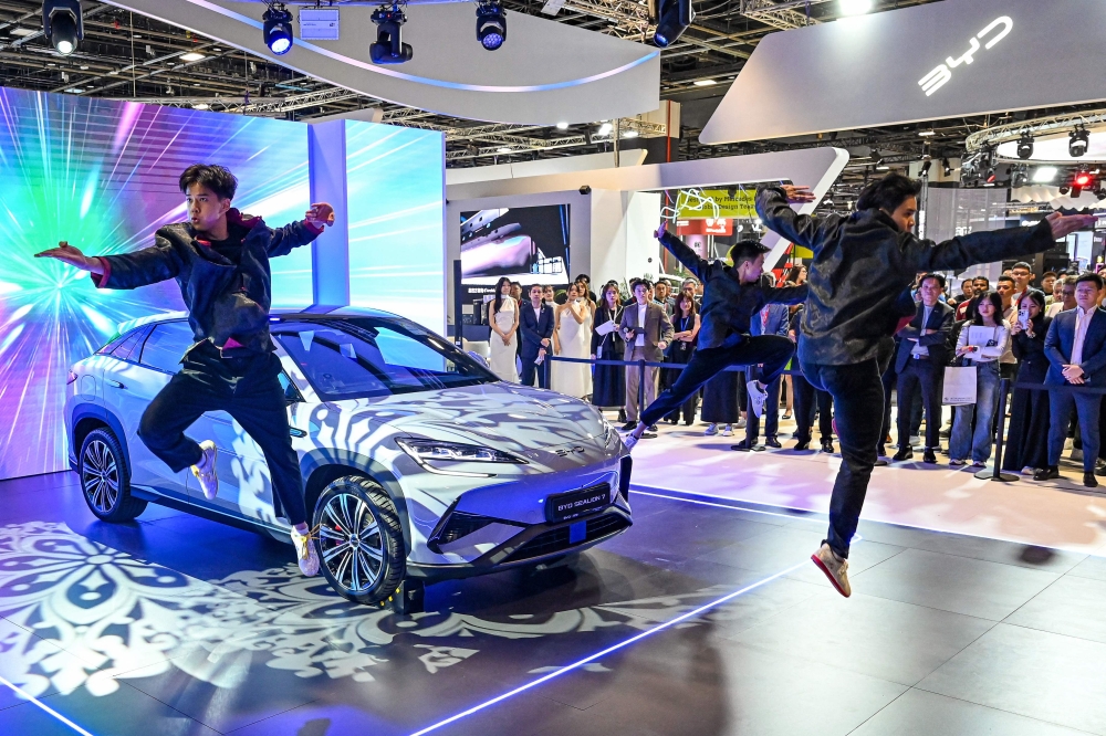 Practitioners perform martial arts next to a BYD Sealion 7 electric vehicle (EV) by Chinese car manufacturer BYD on display at the Singapore Motorshow in Singapore on January 9, 2025. — AFP pic
