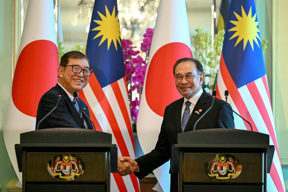 Prime Minister Datuk Seri Anwar Ibrahim and Japan Prime Minister Shigeru Ishiba shake hands during a joint press conference in Putrajaya January 10, 2025. — Bernama pic