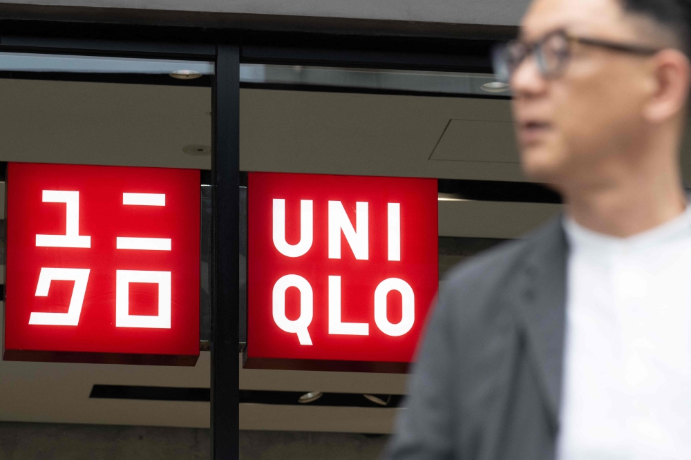 Shares in the owner of Japanese fashion giant Uniqlo fell almost seven per cent on Friday after the company reported a weak quarterly performance in China. — AFP pic