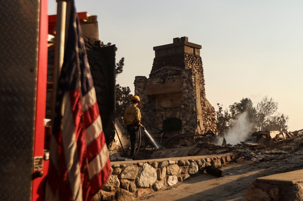 A firefighter works at the site of a burned building, following the Eaton Fire, in Altadena, California, January 10, 2025. — Reuters pic