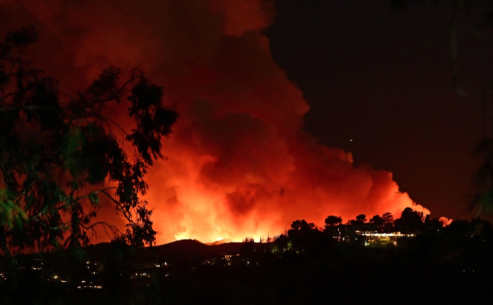 Smoke and flames from the Palisades Fire burn toward the Encino neighbourhood of Los Angeles, California, January 10, 2025. — AFP pic