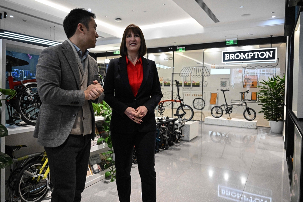 Britain’s Chancellor of the Exchequer Rachel Reeves (right) visits British bicycle brand Brompton’s flagship store in Beijing, China on January 11, 2025. — AFP pic