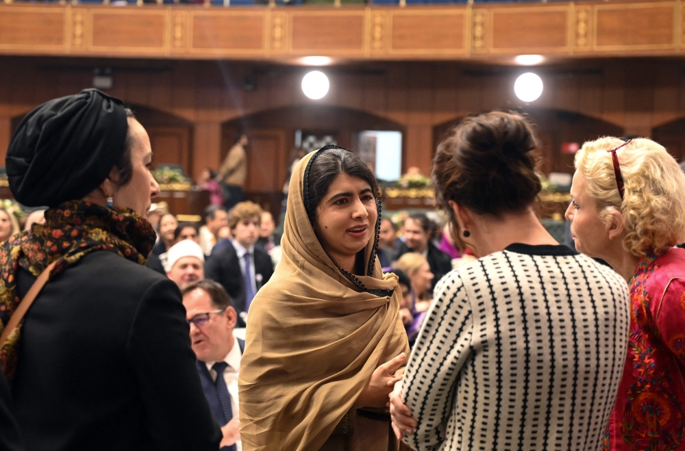 Nobel Peace Prize Laureate Malala Yousafzai meets with delegation members while attending the international summit on ‘Girls’ Education in Muslim Communities’, in Islamabad. — AFP
